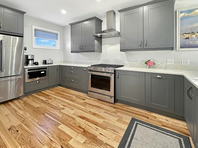 a kitchen with granite countertop a sink stove and cabinets