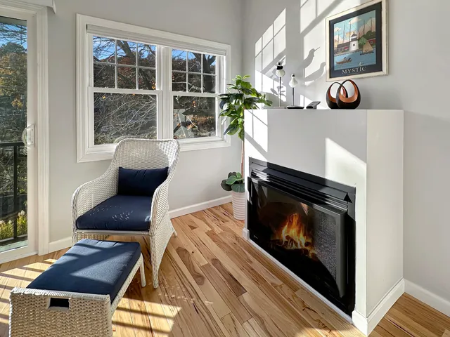 an empty room with a dresser and a window