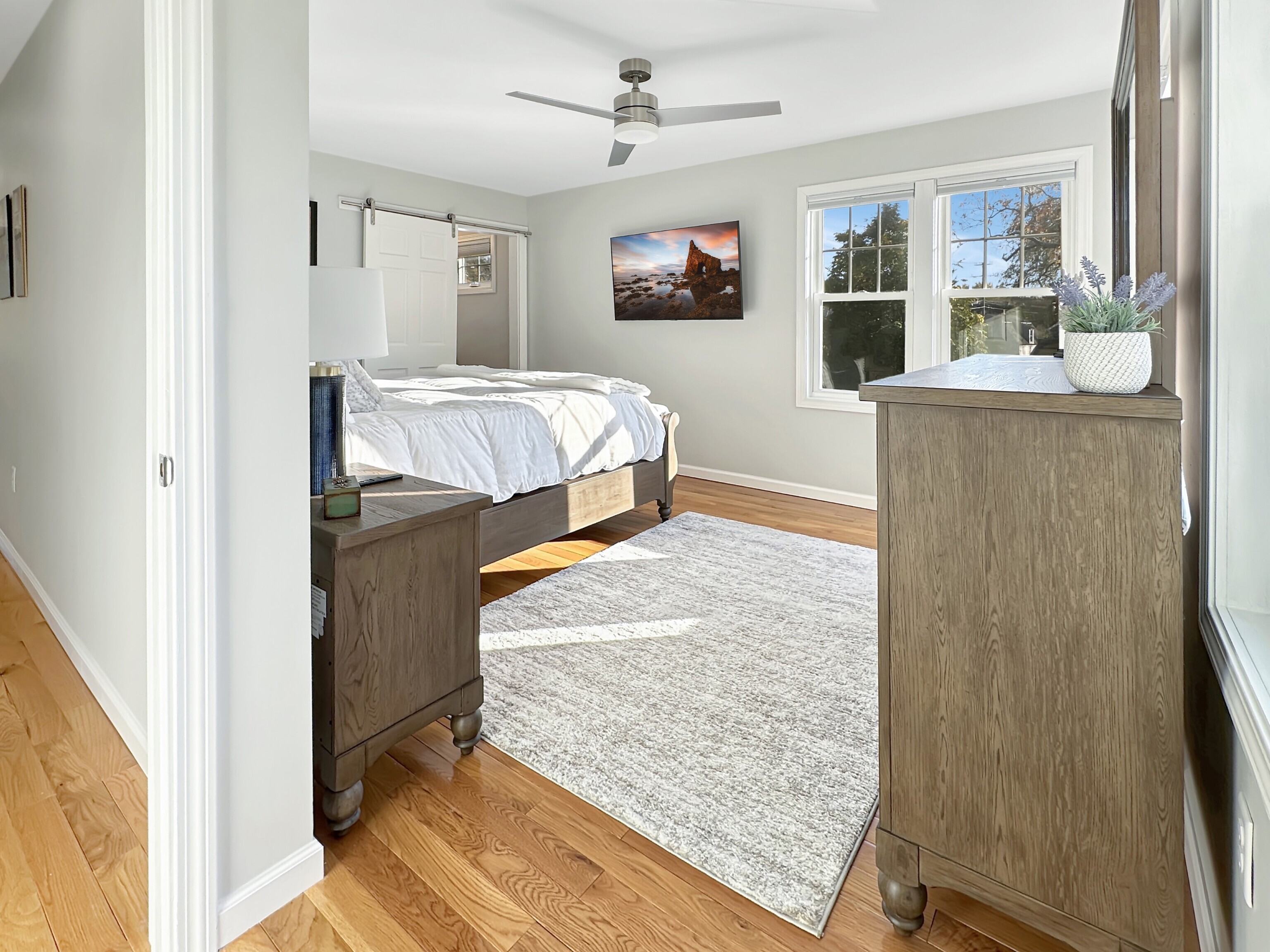 276 Niantic River Road Waterford, CT 06385 - Photo 28 of 40 a bedroom with a bed and flat screen tv