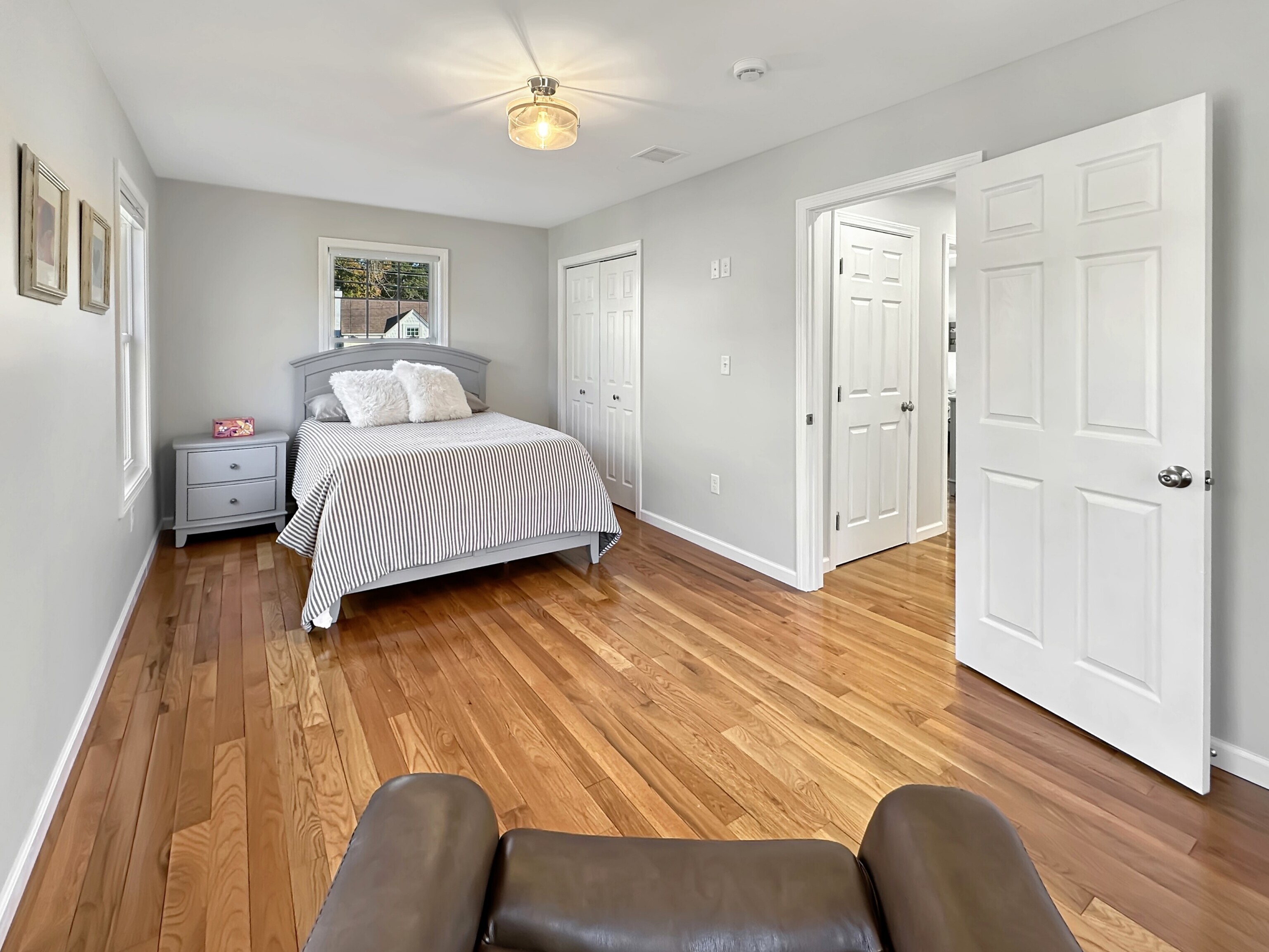 276 Niantic River Road Waterford, CT 06385 - Photo 35 of 40 a bedroom with a bed and wooden floor