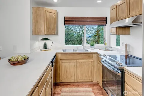 a kitchen with a sink and large window