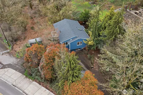 an aerial view of a house with a yard