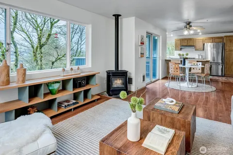 a living room with furniture fireplace and a large window