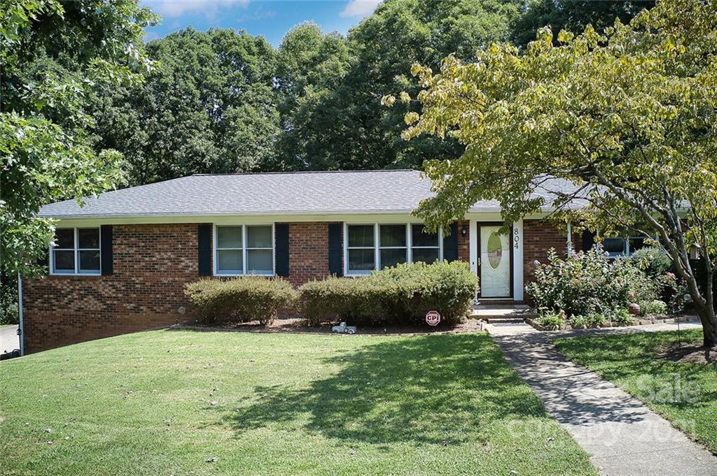 a front view of a house with a yard and porch
