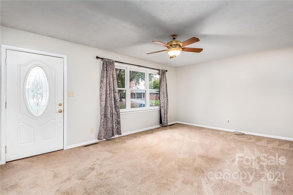 804 Hillside Street Southwest Valdese, NC 28690 - Photo 14 of 25 an empty room with windows and fan