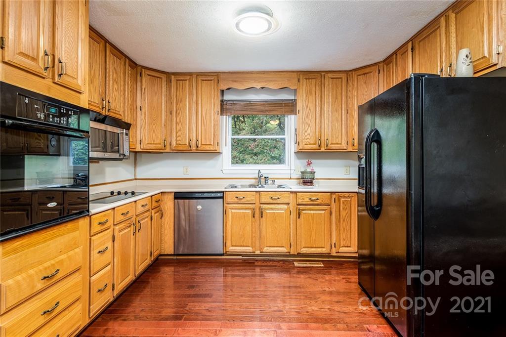 804 Hillside Street Southwest Valdese, NC 28690 - Photo 15 of 25 a kitchen with stainless steel appliances granite countertop a refrigerator and a stove top oven