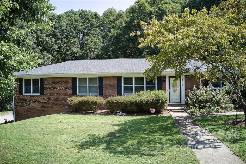 804 Hillside Street Southwest Valdese, NC 28690 - Photo 5 of 25 a front view of a house with a yard and outdoor seating