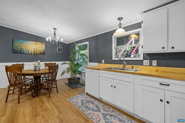 a view of a dining room with furniture and chandelier