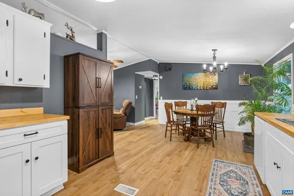 a view of a dining room with furniture and a chandelier