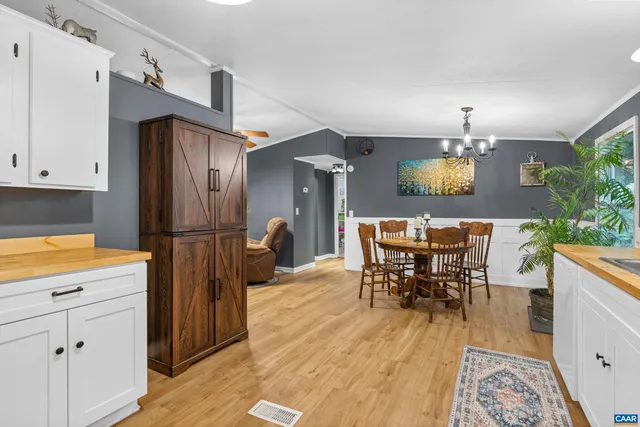 a view of a dining room with furniture and a chandelier