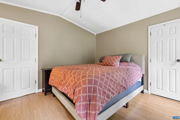 a bed sitting in a bedroom next to a window