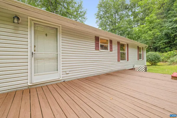 a view of backyard with a deck