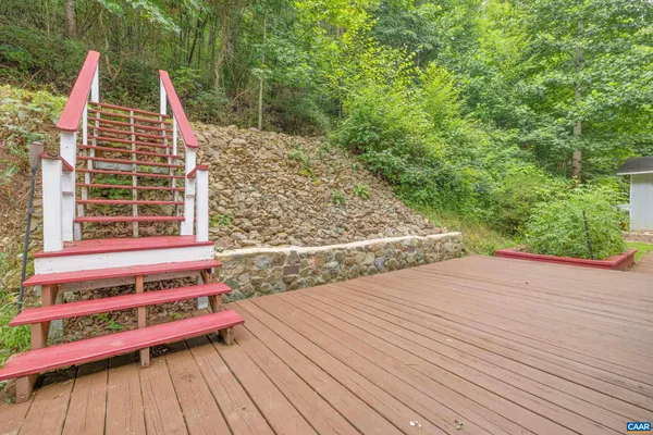 a view of a wooden deck with a yard