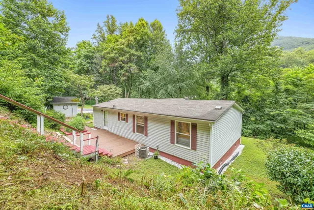 a view of a tiny house with yard