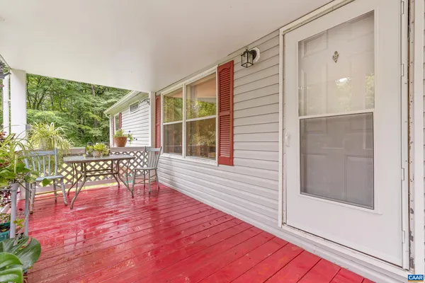 a view of a chairs and table in patio with wooden floor