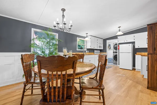 a view of a dining room with furniture and a chandelier