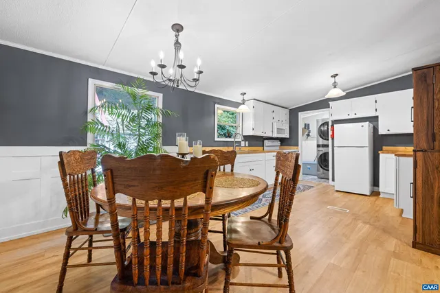 a view of a dining room with furniture and a chandelier