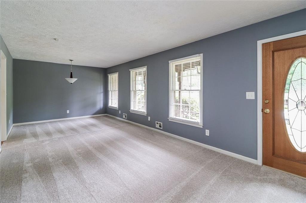 1291 Stephens Street Southwest Lilburn, GA 30047 - Photo 11 of 22 a view of an empty room with large windows