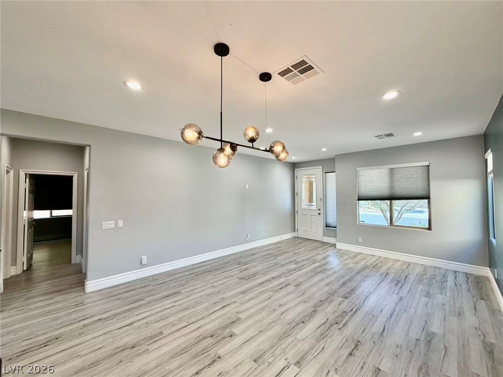 135 Tall Ruff Drive Las Vegas, NV 89148 - Photo 3 of 29 Clean lines and light-toned wood flooring create an inviting, airy living space.