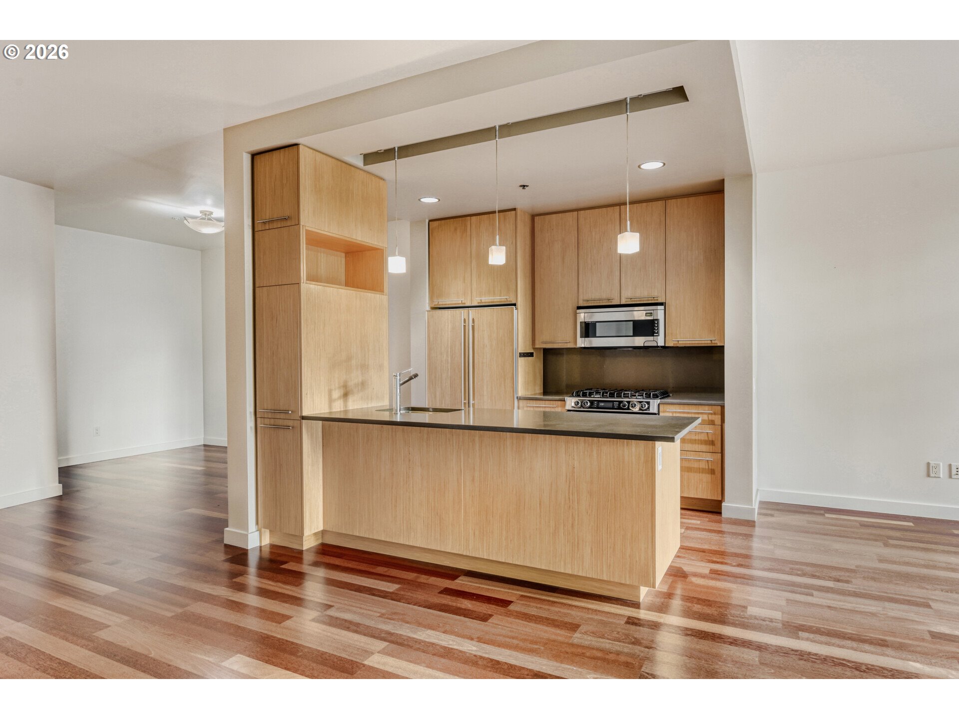 949 Northwest Overton Street, Unit 513 Portland, OR 97209 - Photo 13 of 35 a kitchen with stainless steel appliances granite countertop a sink a stove and a wooden floors