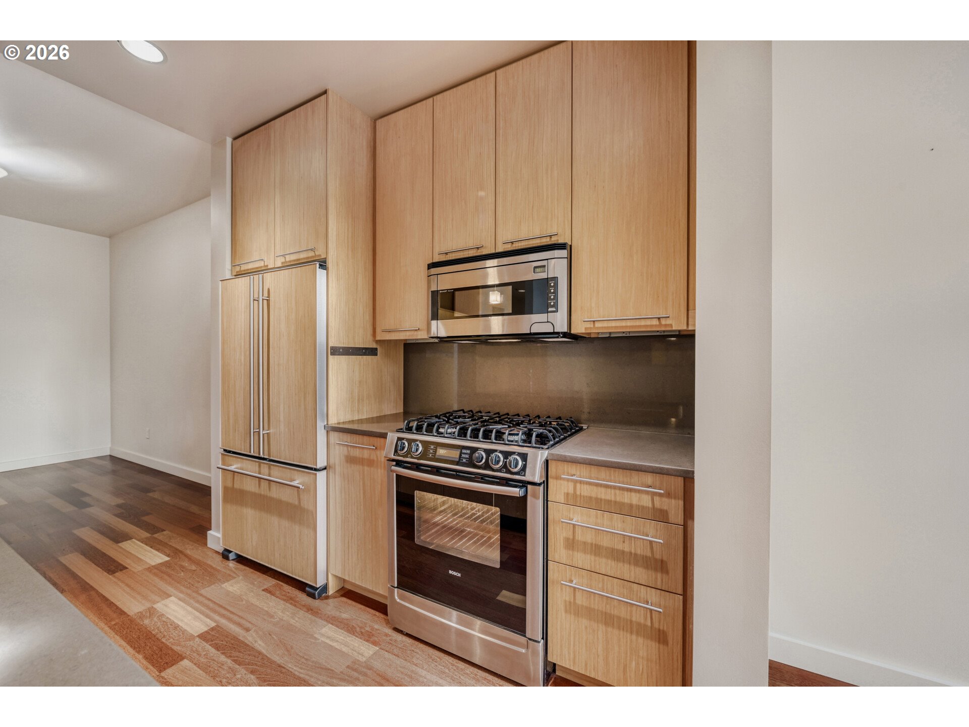 949 Northwest Overton Street, Unit 513 Portland, OR 97209 - Photo 15 of 35 a kitchen with granite countertop a stove microwave and a refrigerator
