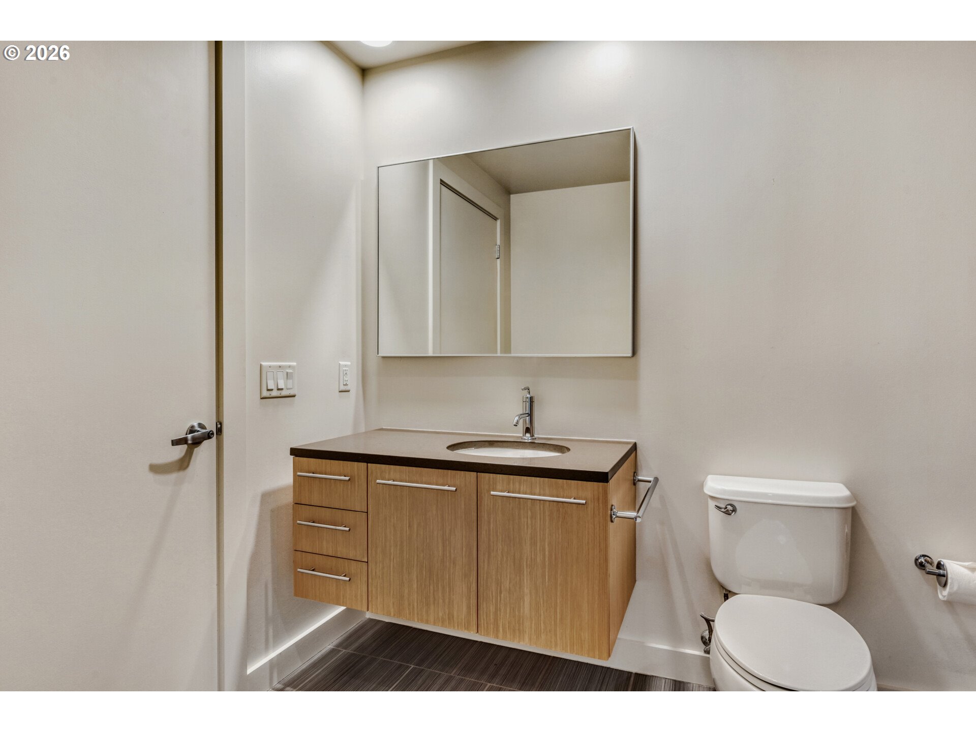 949 Northwest Overton Street, Unit 513 Portland, OR 97209 - Photo 24 of 35 a bathroom with a toilet a sink and mirror