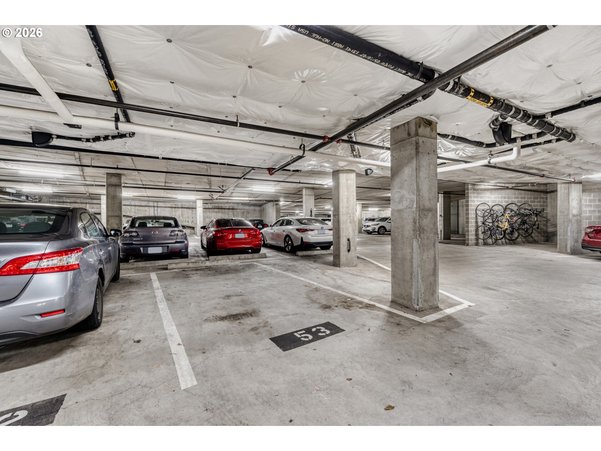 949 Northwest Overton Street, Unit 513 Portland, OR 97209 - Photo 27 of 35 a view of parking garage with cars