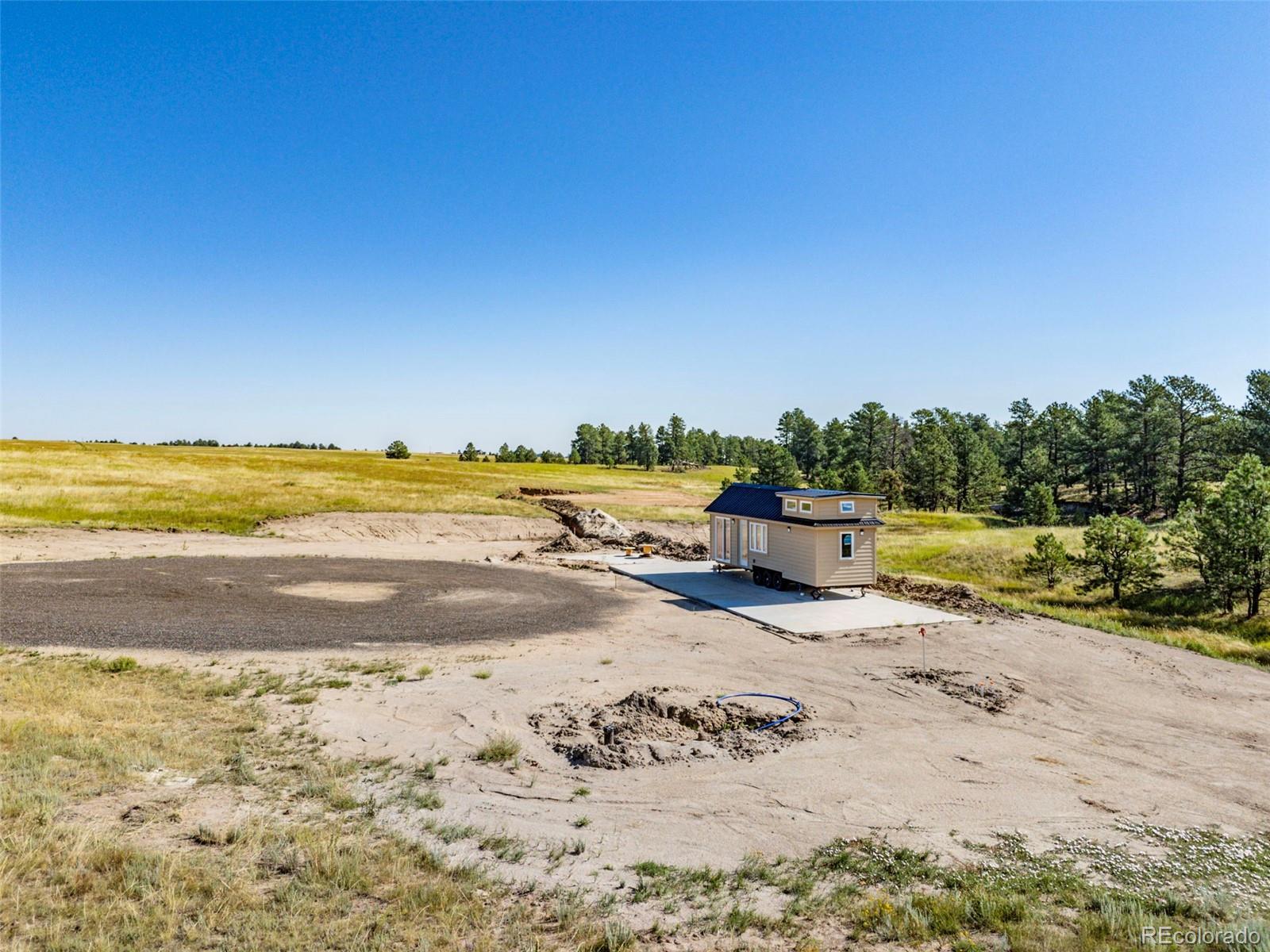 32147 Waylongood Point Kiowa, CO 80117 - Photo 4 of 19 a view of a lake with beach and large trees