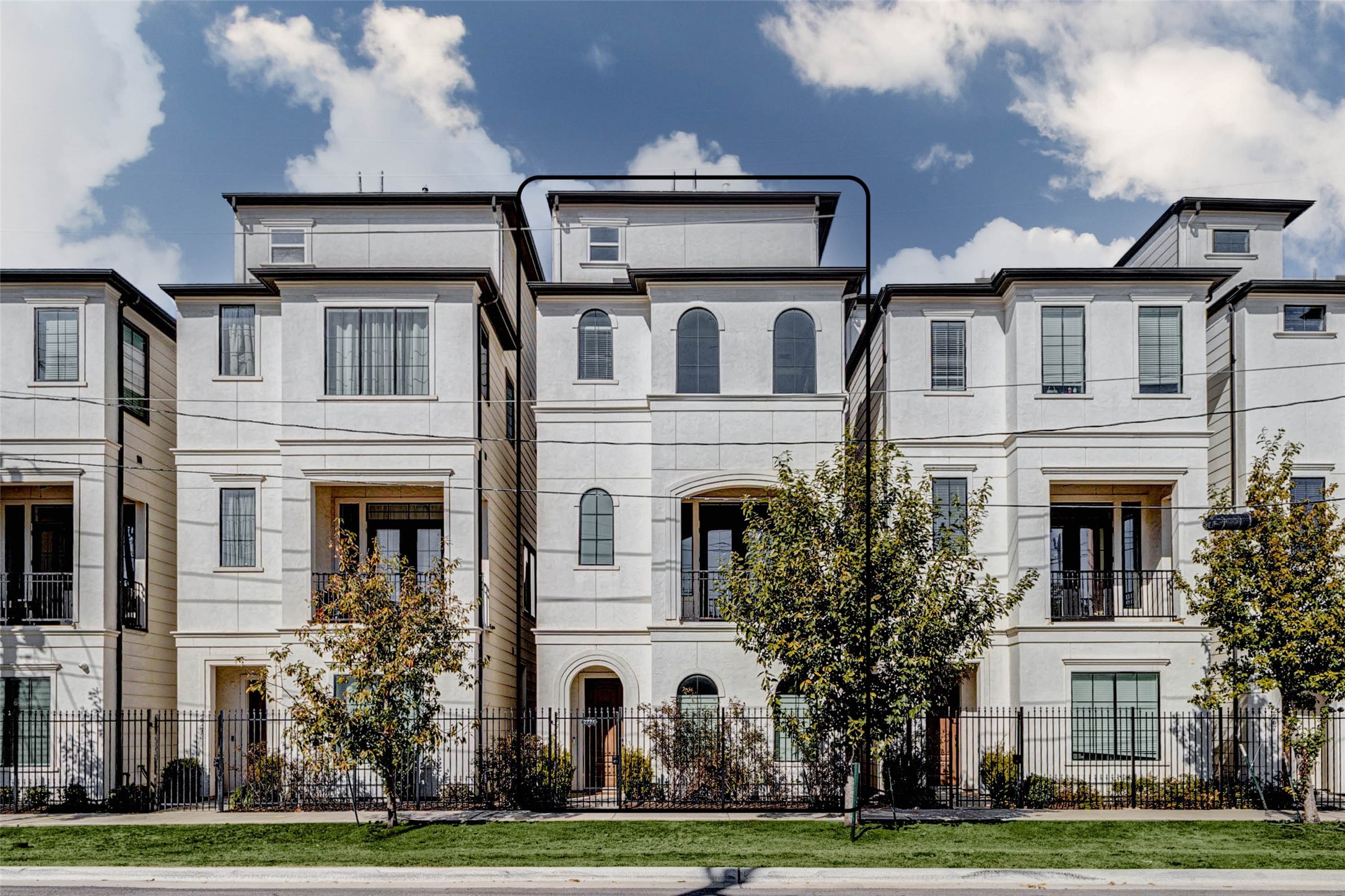 a front view of residential houses with yard