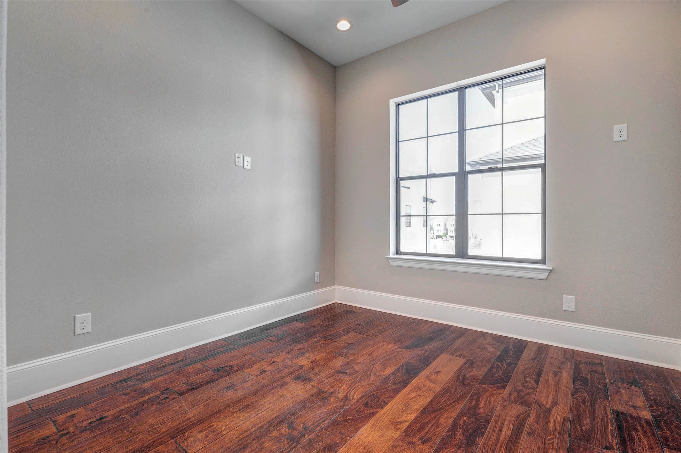 2771 Freund Street Houston, TX 77003 - Photo 13 of 25 an empty room with wooden floor and windows