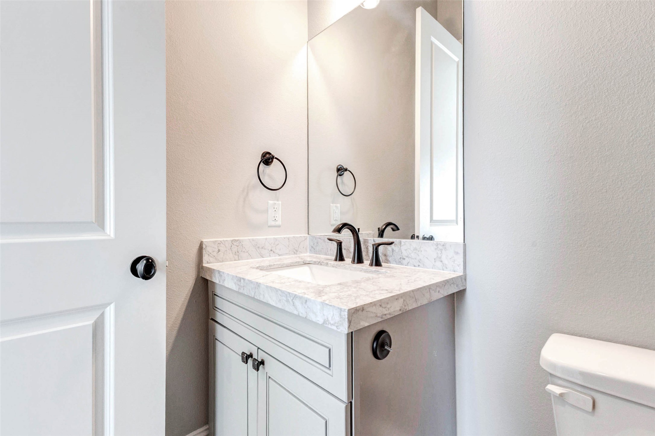 2771 Freund Street Houston, TX 77003 - Photo 4 of 25 a bathroom with a sink and mirror with toilet