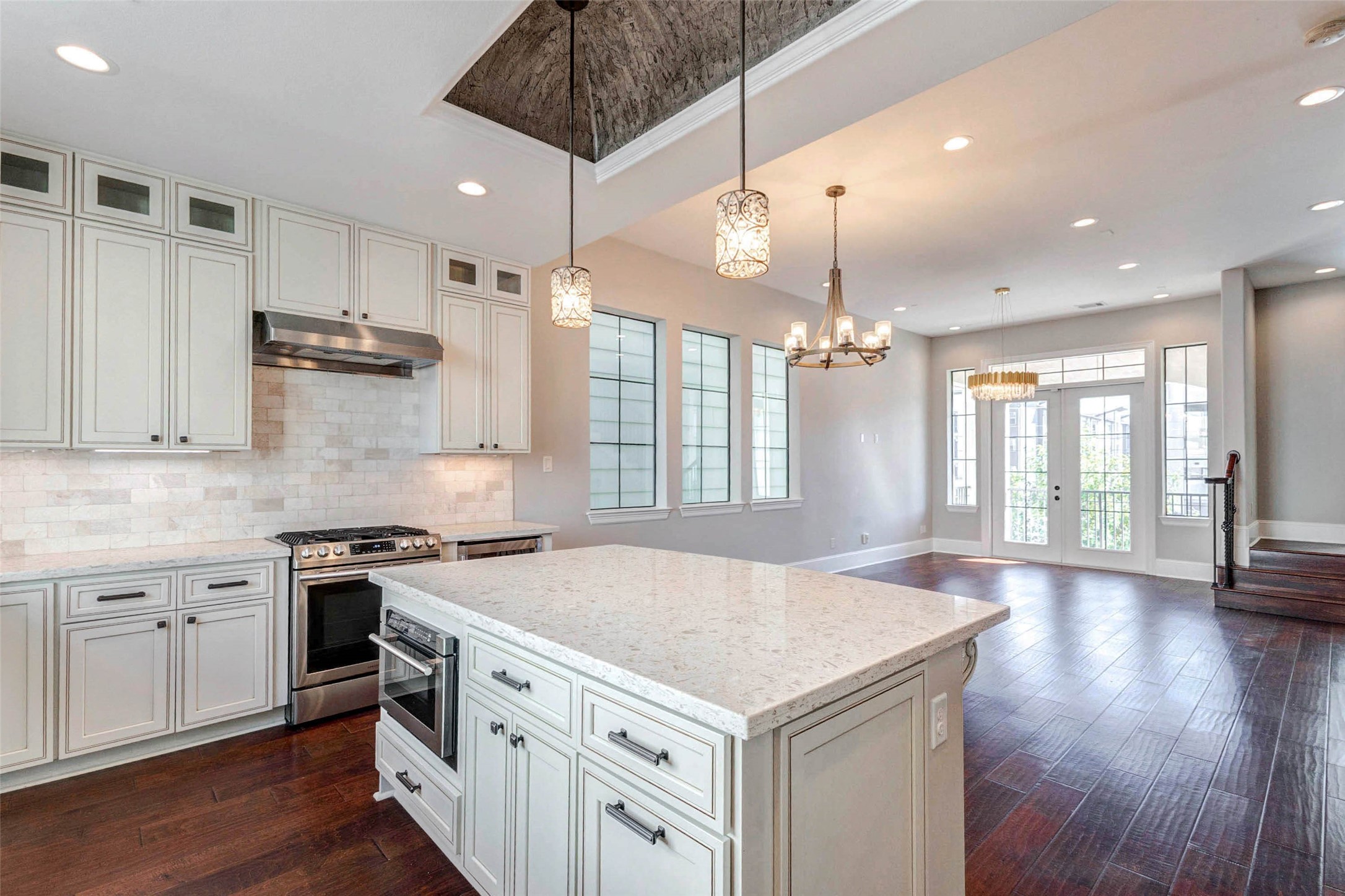 2771 Freund Street Houston, TX 77003 - Photo 8 of 25 a kitchen with a stove a sink a center island and wooden floor