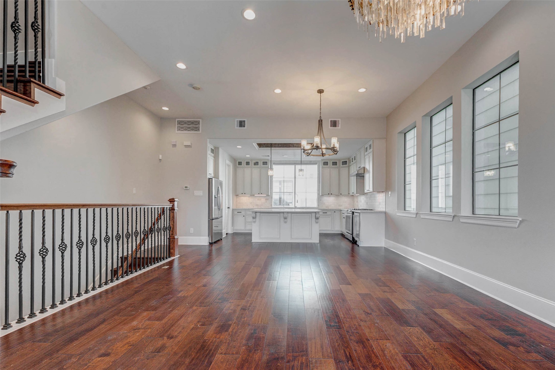 2771 Freund Street Houston, TX 77003 - Photo 9 of 25 a view of empty room with wooden floor and windows