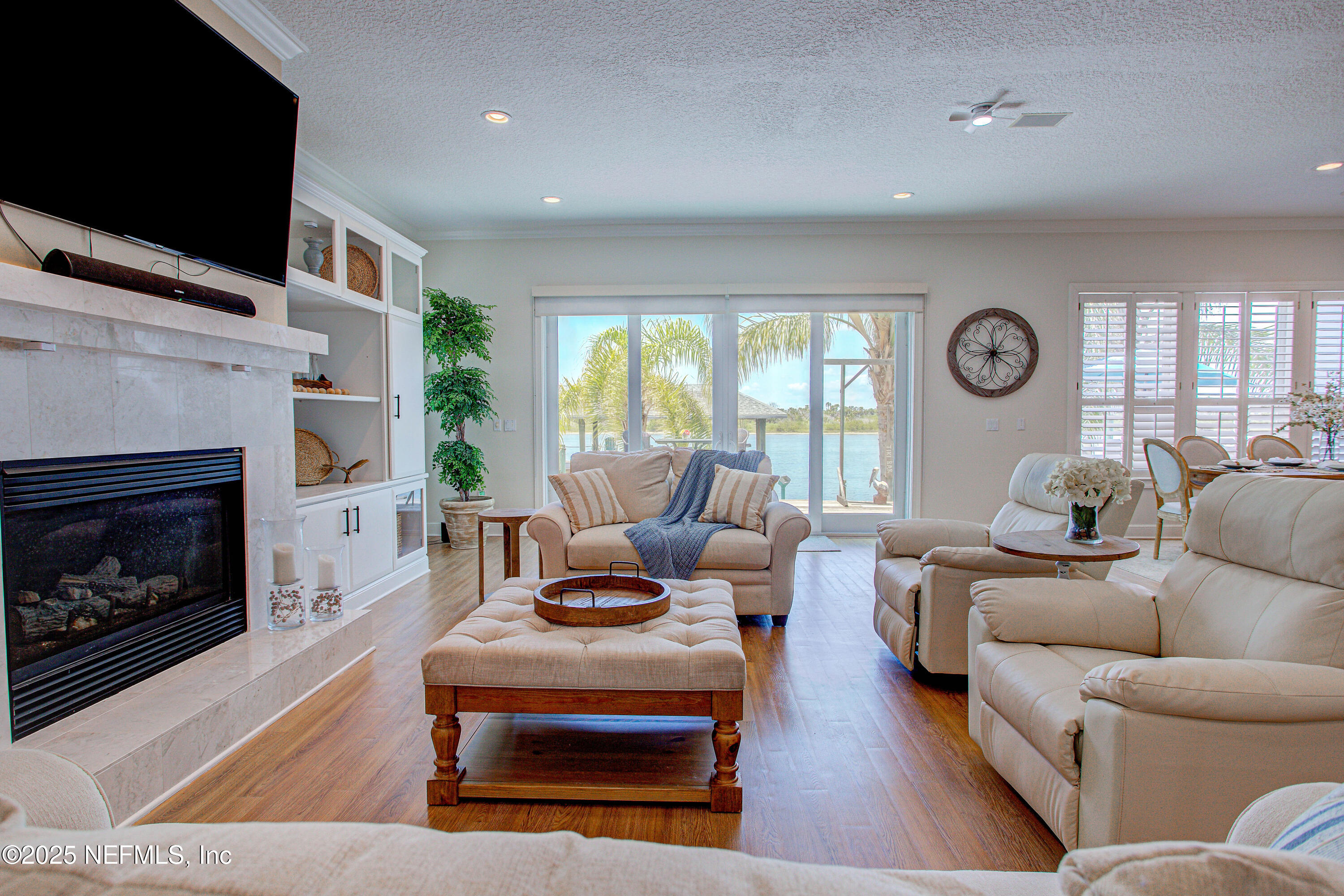 9155 June Lane St. Augustine, FL 32080 - Photo 13 of 43 a living room with furniture fireplace and a flat screen tv