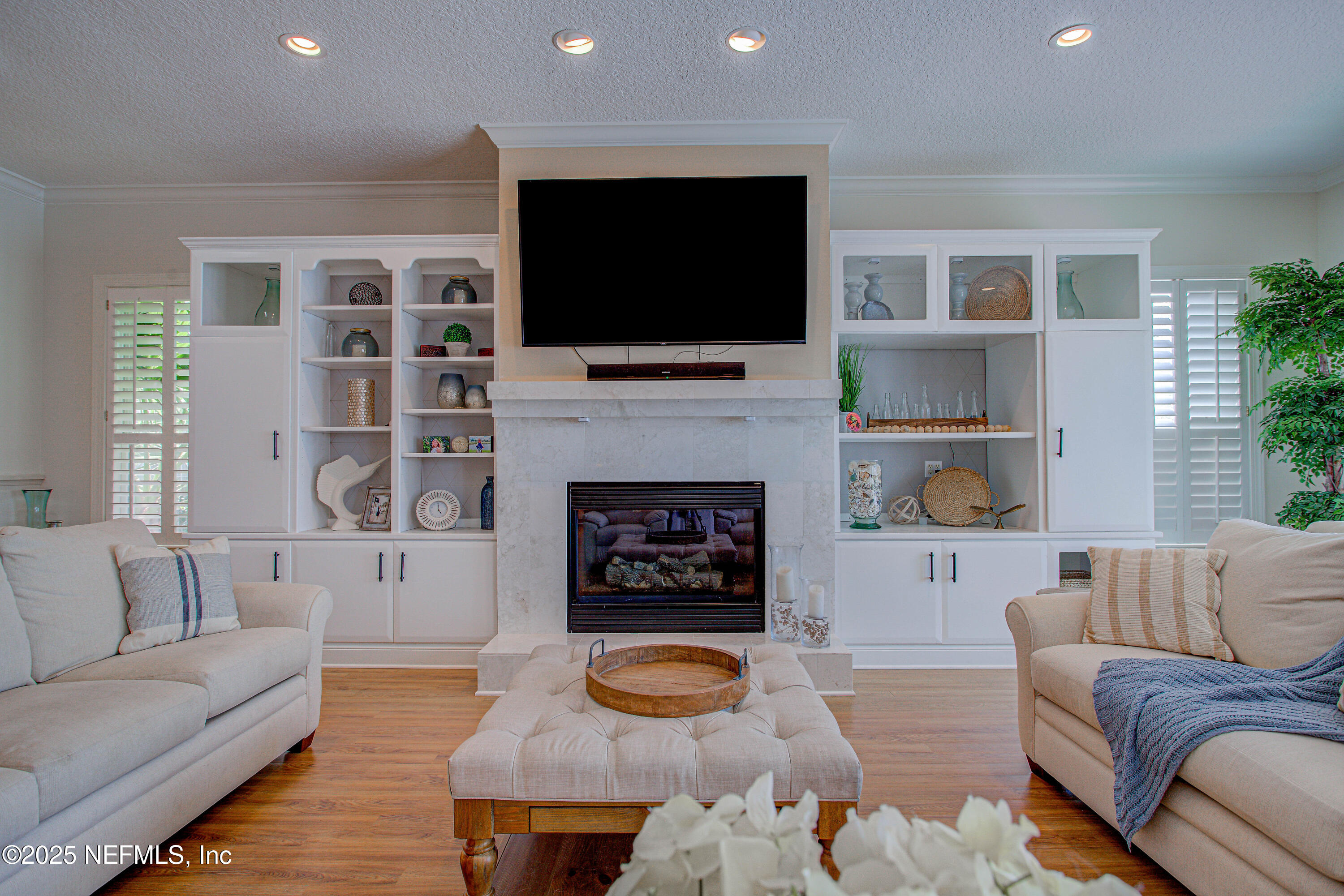 9155 June Lane St. Augustine, FL 32080 - Photo 14 of 43 a living room with furniture fireplace and flat screen tv