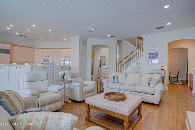 a kitchen with cabinets appliances and a wooden floor
