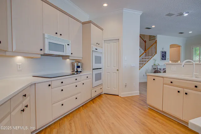 a view of a kitchen with kitchen island wooden floor and center island