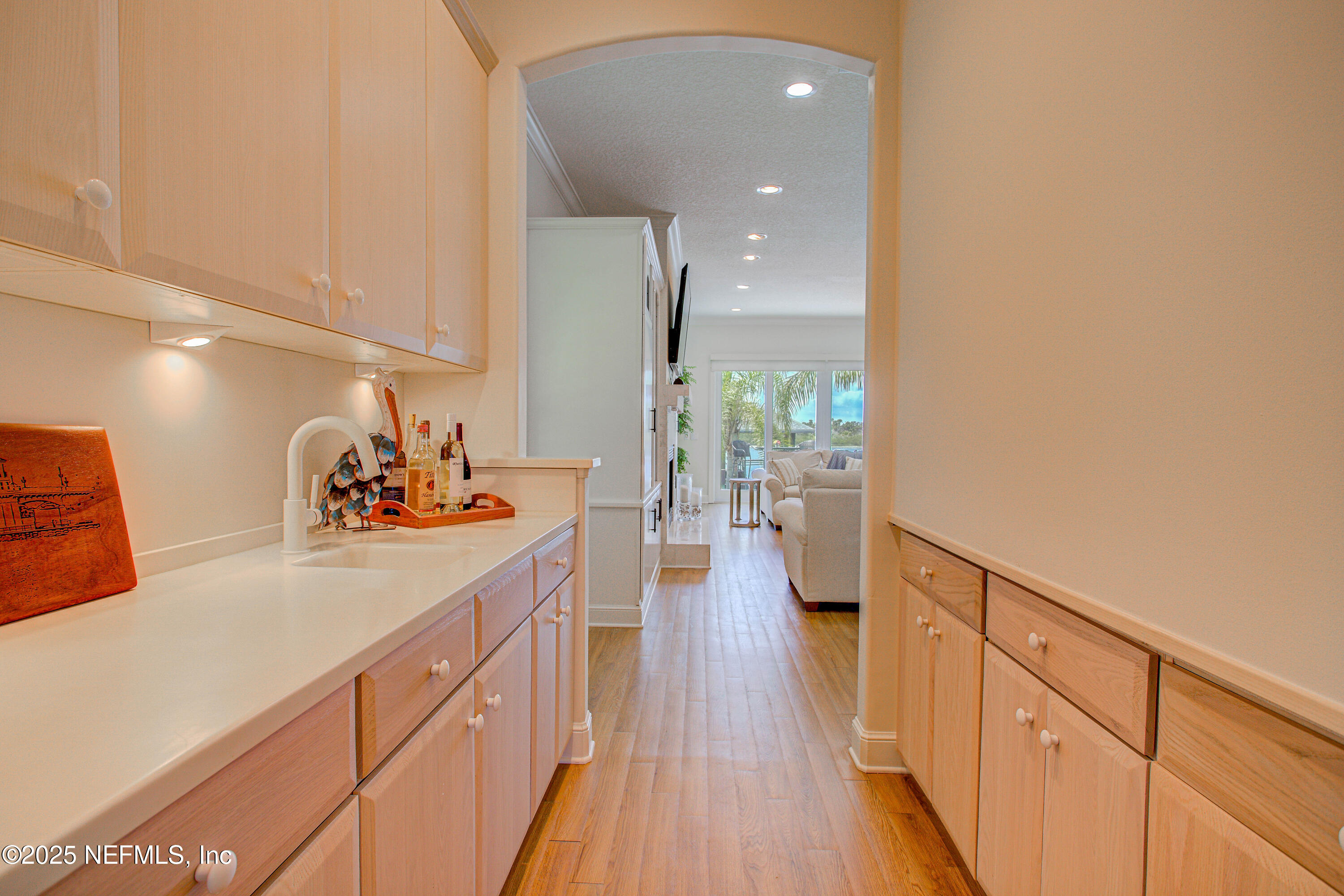 9155 June Lane St. Augustine, FL 32080 - Photo 19 of 43 a view of a kitchen with kitchen island wooden floor and center island