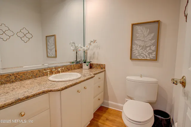 a bedroom with a bed and a flat tv screen on dresser
