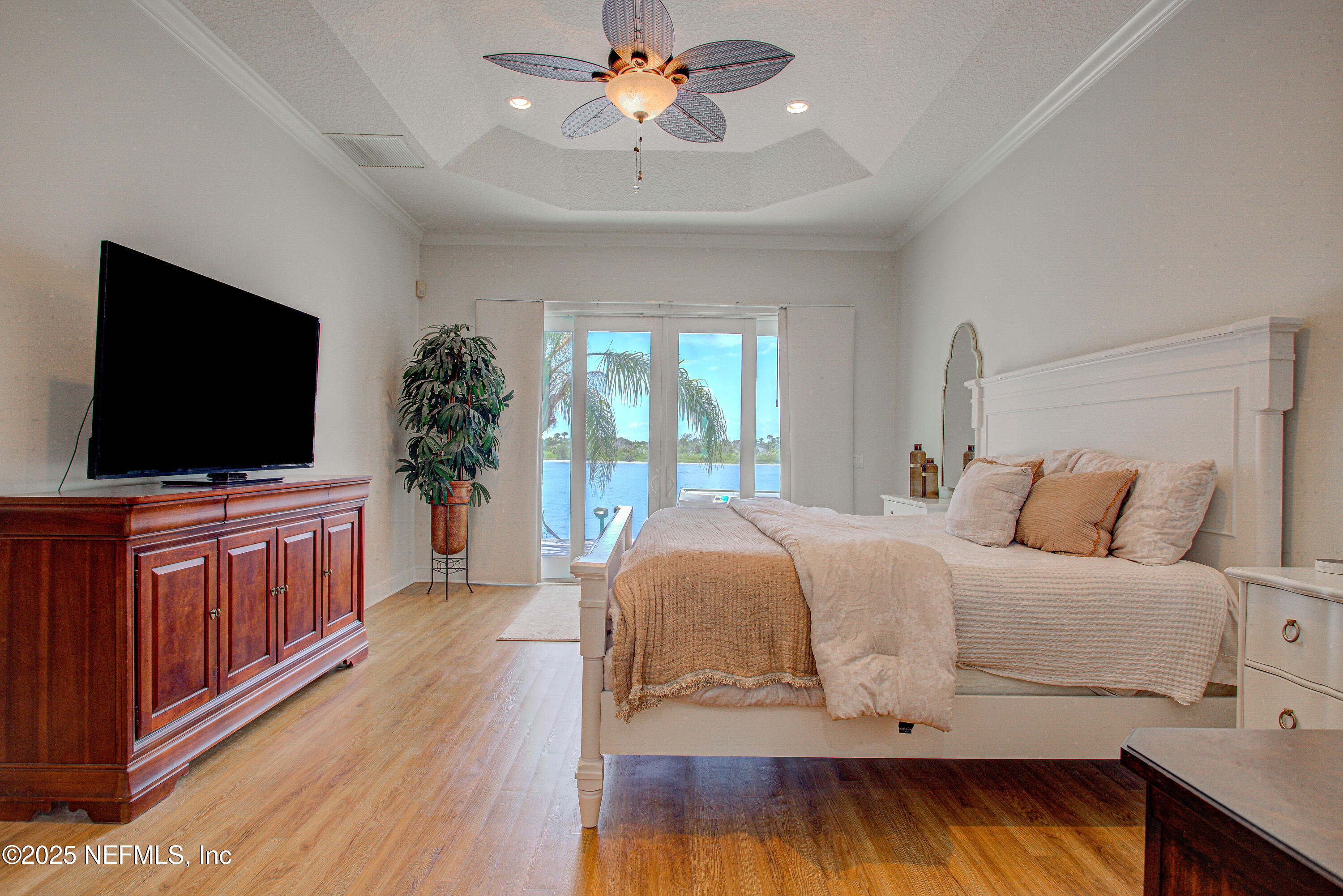 9155 June Lane St. Augustine, FL 32080 - Photo 23 of 43 a bedroom with a bed and a flat screen tv