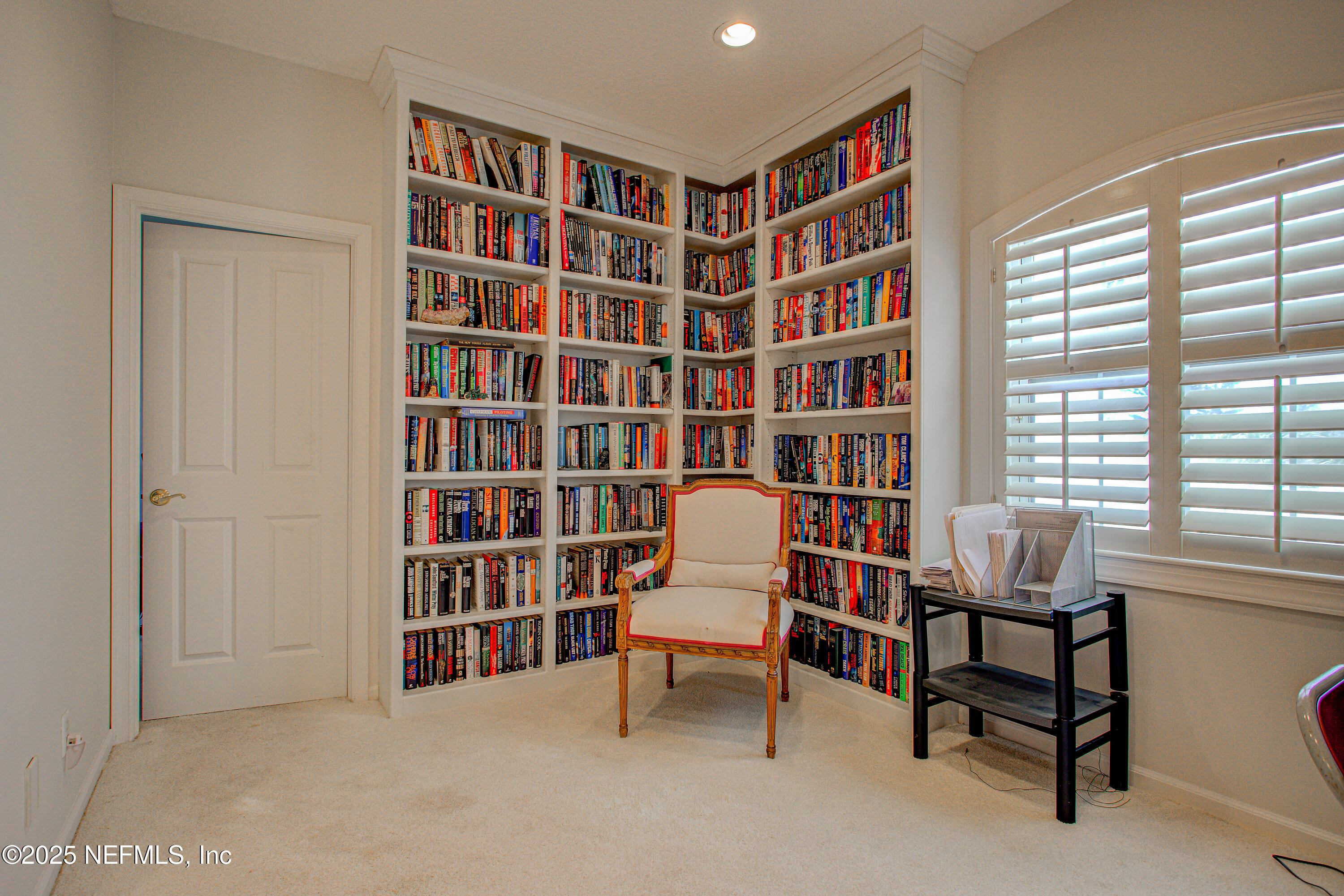 9155 June Lane St. Augustine, FL 32080 - Photo 27 of 43 a view of a livingroom with furniture and a bookshelf