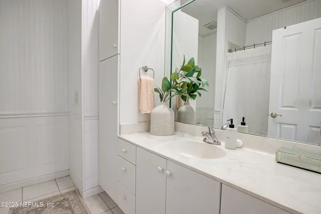 a spacious bedroom with a bed and a large window