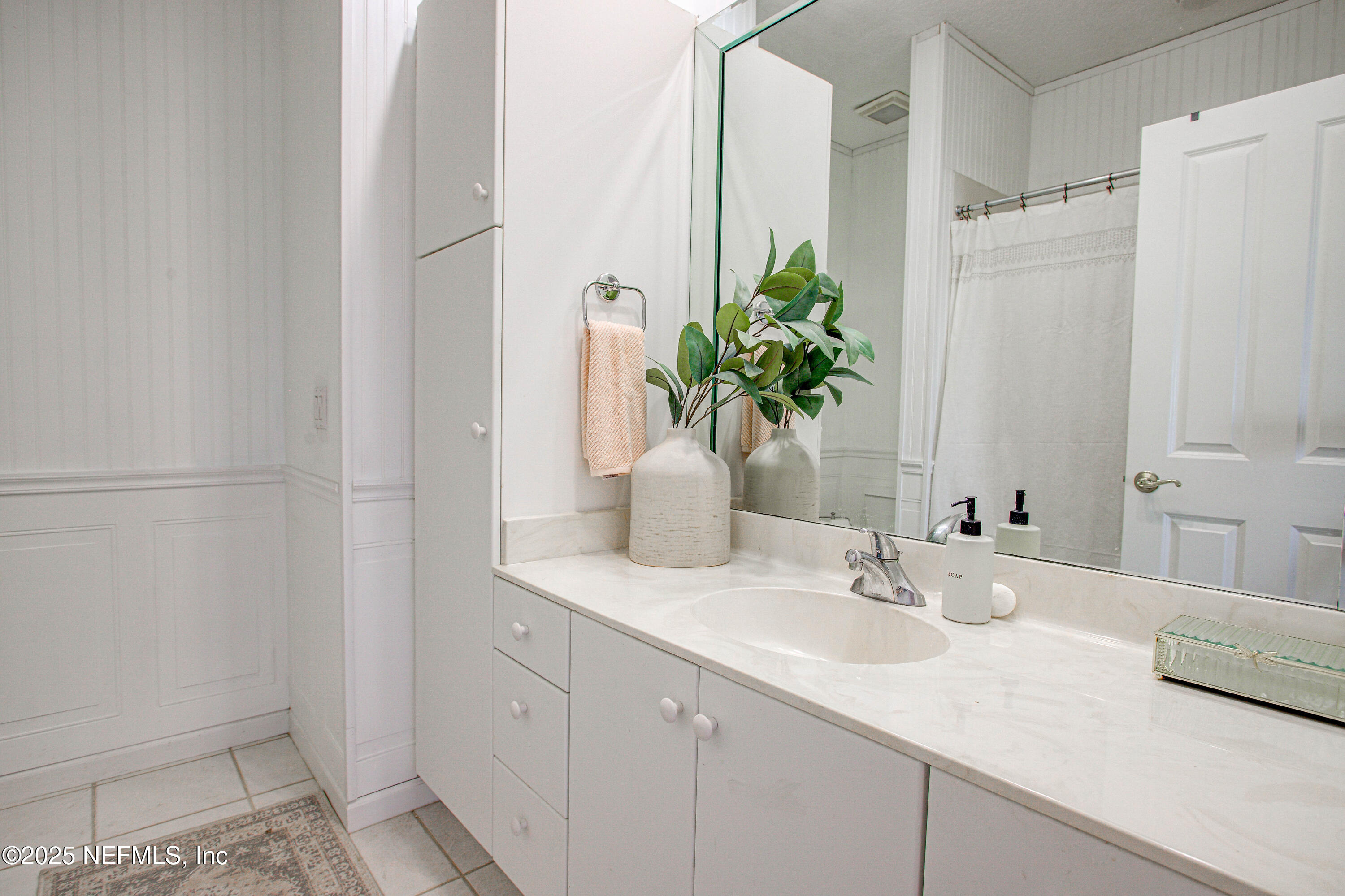 9155 June Lane St. Augustine, FL 32080 - Photo 31 of 43 a bathroom with a sink a vanity and a mirror