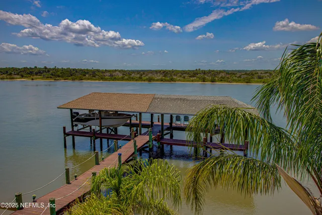a view of a house with a swimming pool and sitting area