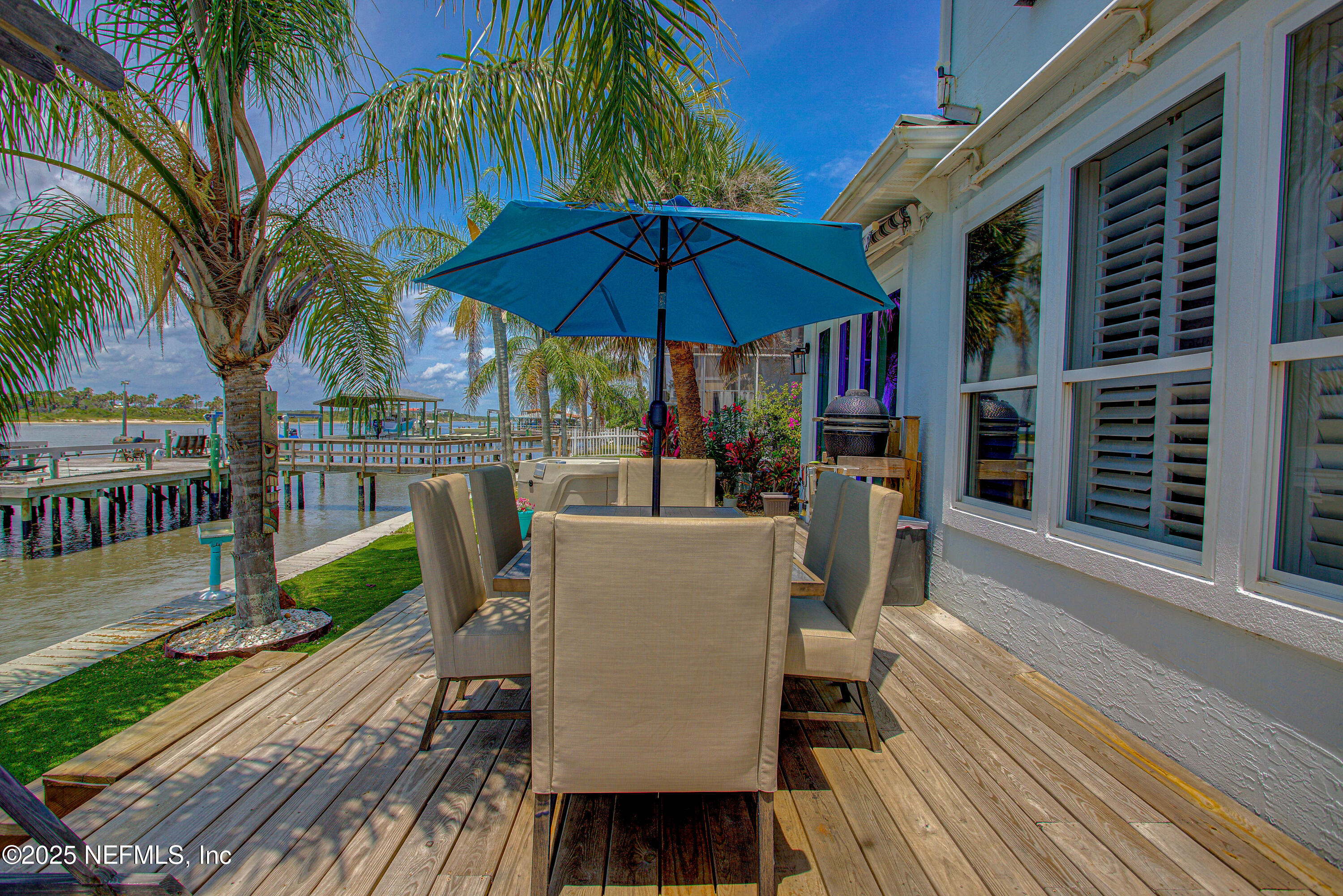 9155 June Lane St. Augustine, FL 32080 - Photo 38 of 43 a view of a chairs and table on the wooden deck in front of a house