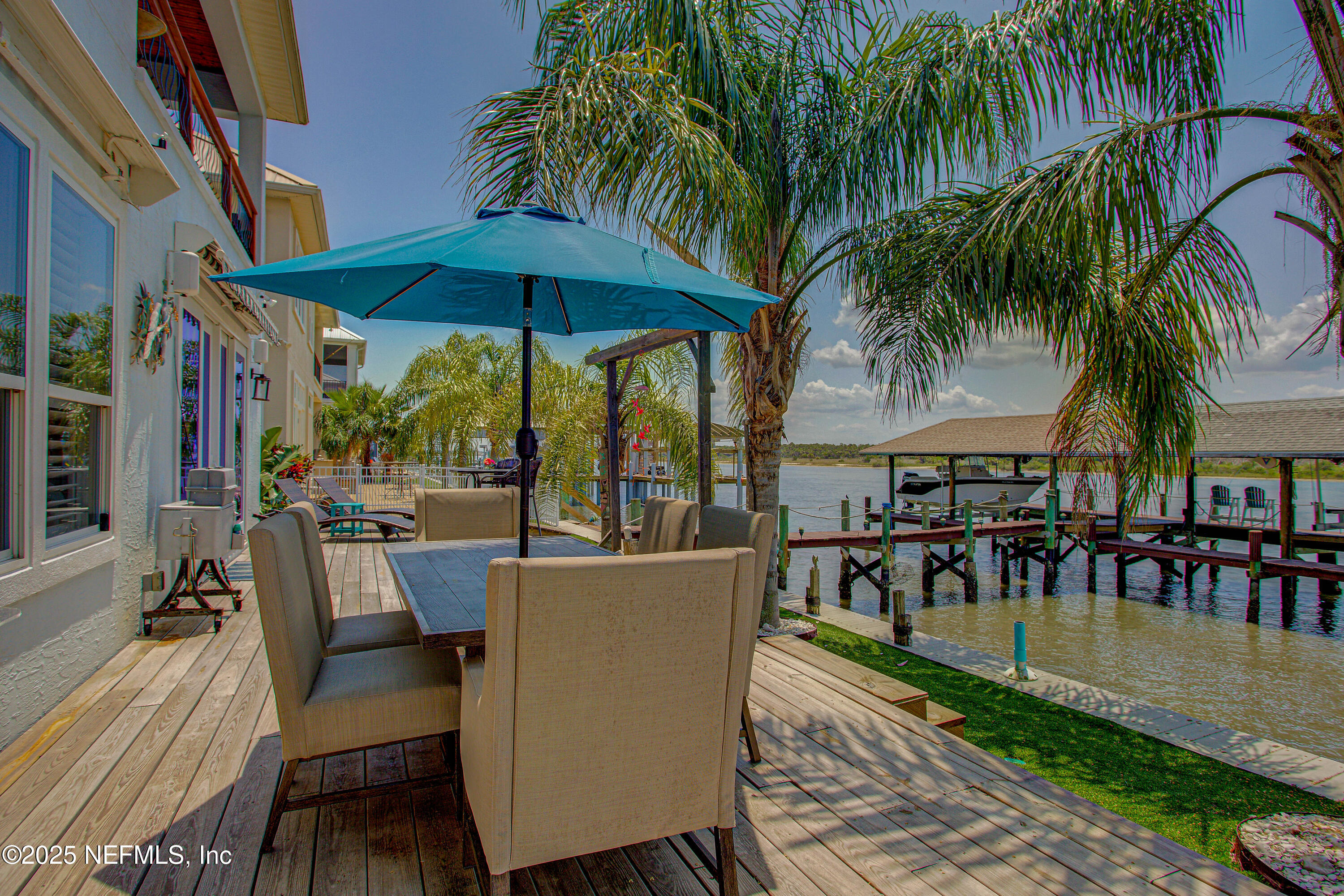 9155 June Lane St. Augustine, FL 32080 - Photo 40 of 43 a view of a swimming pool with a table and chairs