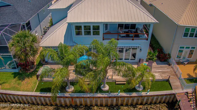 a front view of a house with a yard and potted plants