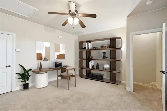 a view of an empty room with cabinet and a window