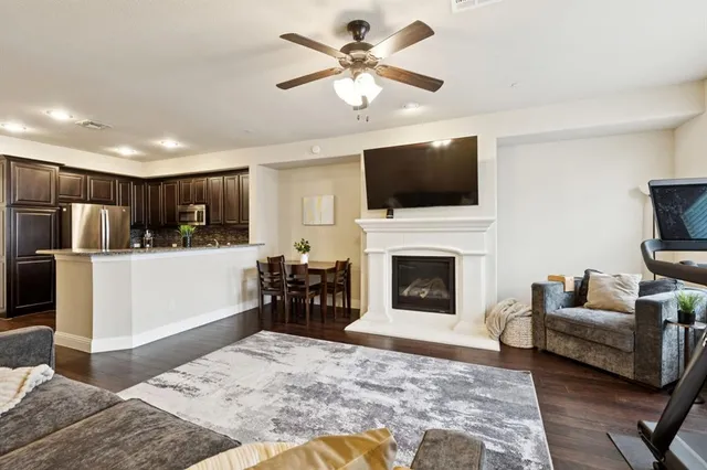 a living room with furniture a fireplace and a flat screen tv