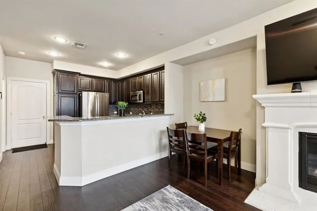a metallic refrigerator freezer sitting in a kitchen